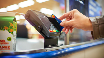 Small pic swiping credit card to pay for groceries istock 926538894